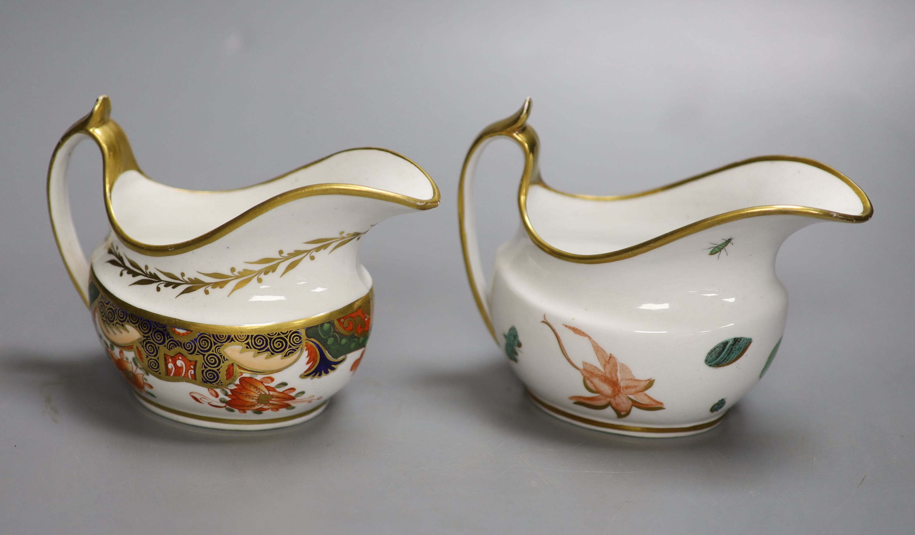 A Spode cream jug painted with Imari pattern 1645 and a Spode cream jug painted with flowers and insects pattern 1025, tallest 10cm